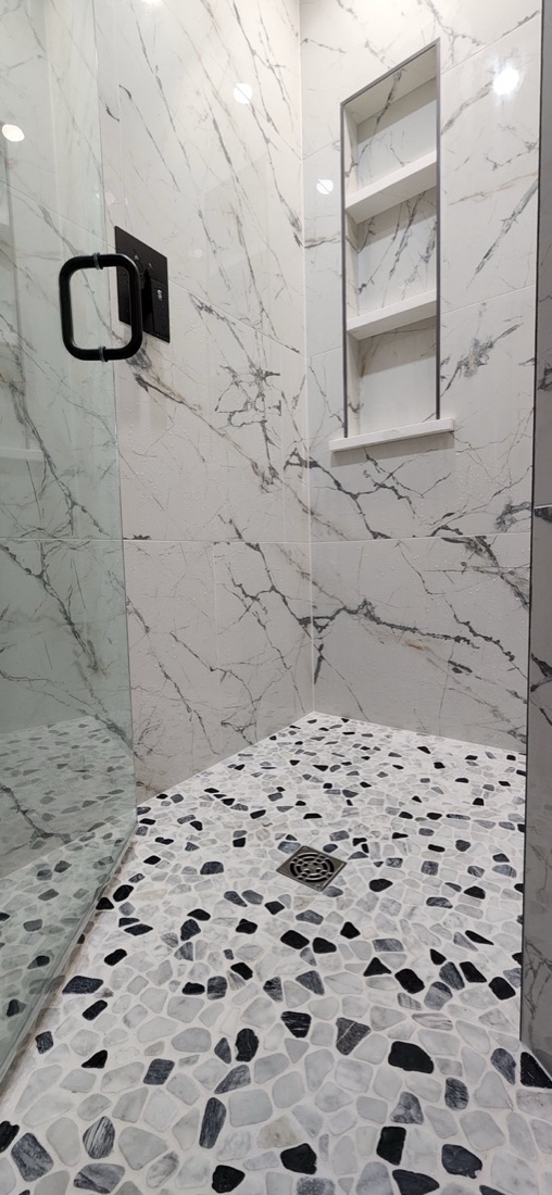 Copper Elegance shower with reused glass enclosure, white veined wall tile and a mosaic shower floor