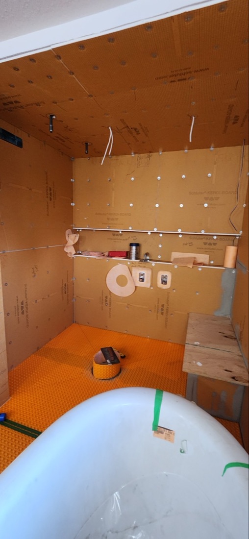Luminous Smoke KERDI-BOARD wall preparation with niche, fasteners and pipe openings before tiling